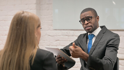 Close up of African Businessman Discussing Business Plan at Meeting