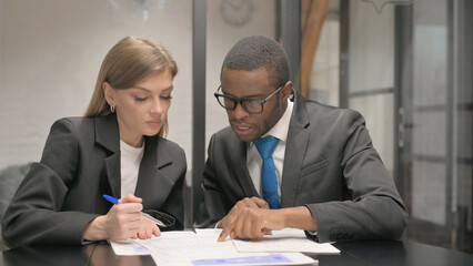 Business People Working on Documents in Office