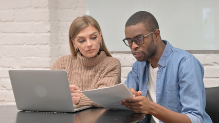 Multi Ethnic People Working on Laptop and Documents, Paperwork