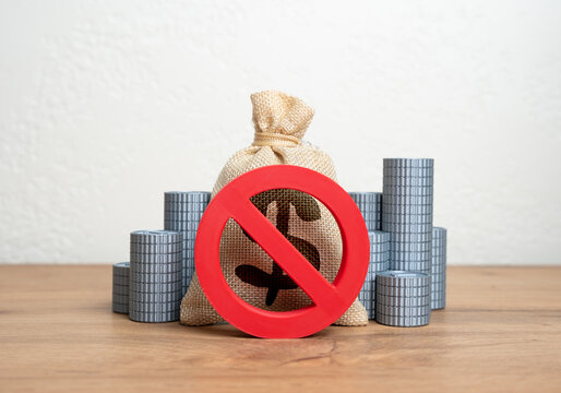 The NO prohibition sign covers the dollar money bag and stacks of coins. Freezing or confiscation of financial assets. Anti-money laundering actions, asset seizure, or economic retaliation.