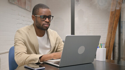 African Man Busy Working on Laptop