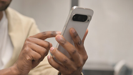 Close up of African Man Hand Using Phone