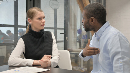 Fototapeta premium Angry Middle Aged Man Talking With Female Colleague During Meeting