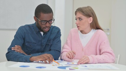 Close up of Young Teammates Working on Documents