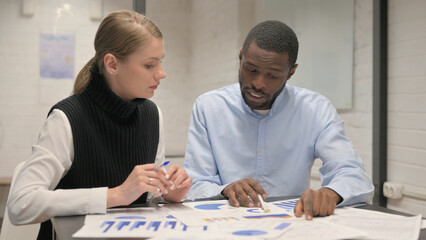 Young Teammates Working on Business Report