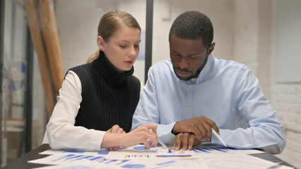 Paperwork by Young Teammates, Working on Business Report