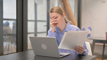 Frustrated Young Woman Reacting to Bad Business Report while Working on Laptop