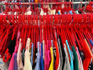 red hangers with colorful clothes