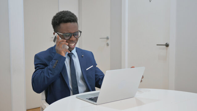 African Businessman Reacting Strongly on a Phone Call