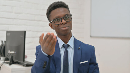 Portrait of Young Businessman Gesturing to Come Here