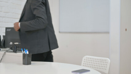 Businessman Leaving Office Desk after Work