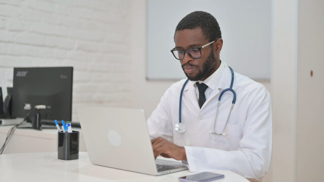 African American Doctor Working on Laptop