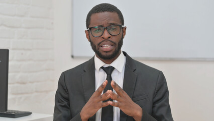 Young African Businessman Explaining with Hand Gesture During Video Chat