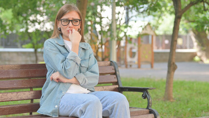 Anxious Woman Crying on a Park Bench