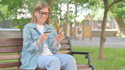 Young Woman Making an Online Purchase with a Credit Card on a Phone