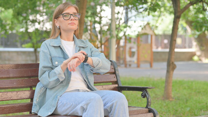 Waiting Young Woman Checking Wrist Watch on Park Bench