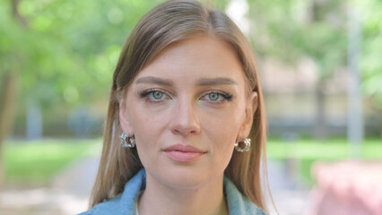 Close-up of a Serious Young Woman Face