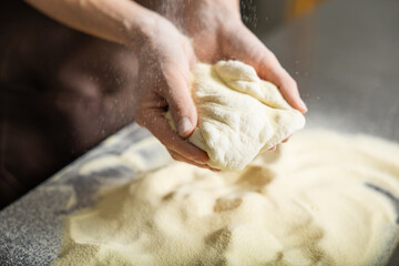 Person rolls dough kitchen flattening carefully preparing pizza meal