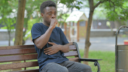 Obraz premium Coughing African American Man Sitting Outdoor