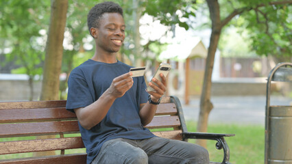 African American Man Enjoying Online Banking Outdoors
