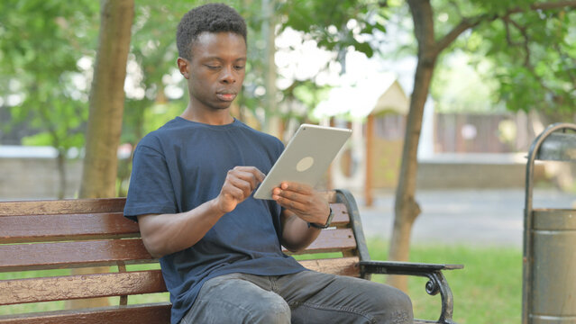 African American Man Using a Digital Tablet Outdoor