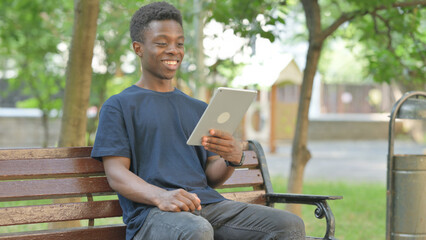 Video Calling on a Tablet by African American Man Outdoor