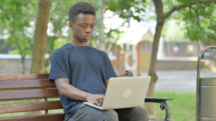 African American Man Using Laptop Outdoor