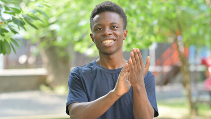 Appreciating Casual African Man Clapping Outdoors