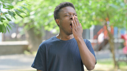 Portrait of Tired Casual African Man Yawning Outdoors