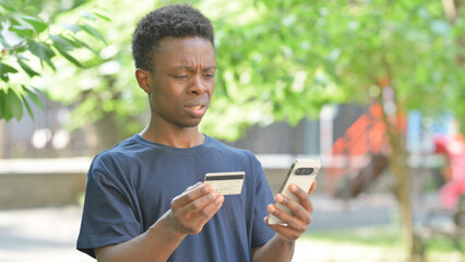 Casual African Man with Online Transaction Failure Outdoors