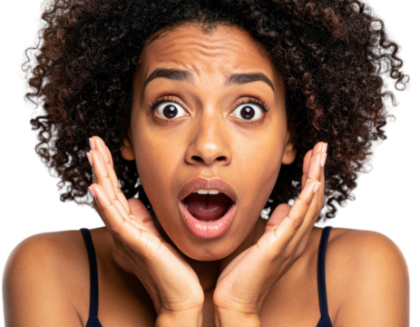 Portrait of surprised young woman with curly hair showing shocked facial expression with hands framing face against white background