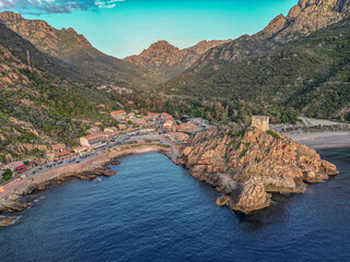 Aerial view town ruins Genoese tower of Porto Corsica France medieval watchtower Mediterranean Sea...