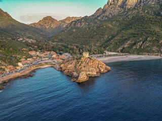 Aerial view town ruins Genoese tower of Porto Corsica France medieval watchtower Mediterranean Sea...