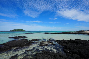 clear rock beach and charming clouds
