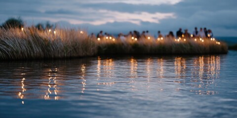 Obraz premium Candlelight reflections shimmer on water as a community gathers to honor Indigenous Peoples Day at dusk