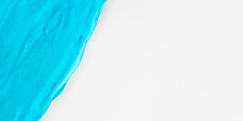 The texture of a blue cosmetic gel on a white background