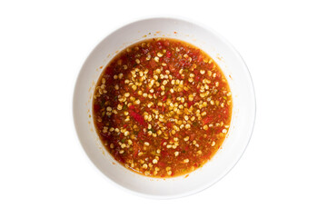 Spicy Delight: Close-up shot of a small, circular bowl filled with vibrant red chili sauce, with small peppers on it. a visual representation of culinary zest.