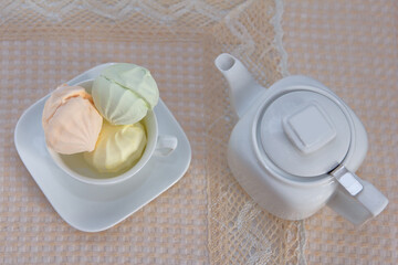 On a served table with a beige tablecloth are stunning, fresh, sweet three marshmallows of...