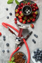 Hookah and fresh fruits on grey table, flat lay