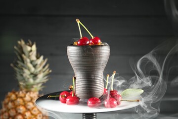 Hookah with cherries and smoke on black background, closeup