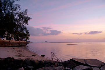 Tranquil Coastal Sunset Scene with Vibrant Skies and Calm Waters