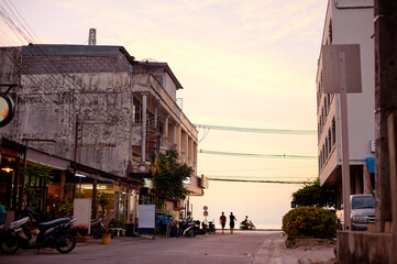 Quiet Thailand City Street With Sunset Sky and People in the Distance