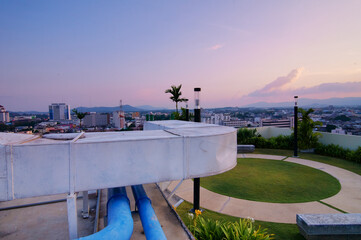 Fototapeta premium Scenic Cityscape View from Modern Rooftop Garden at Sunset
