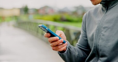 Hands, bridge and man with smartphone, fitness and social media with message to contact. Closeup, person and runner with cellphone, outdoor and digital app to track progress, workout and connection - Powered by Adobe