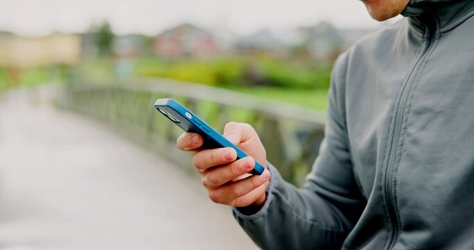 Hands, bridge and man with smartphone, fitness and social media with message to contact. Closeup, person and runner with cellphone, outdoor and digital app to track progress, workout and connection