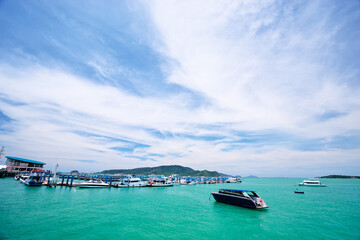 Serene Coastal Landscape with Boats and Blue Sky in Tropical Setting