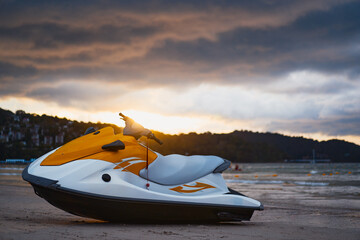 Bright Yellow Jet Ski on Beach during a Stunning Sunset