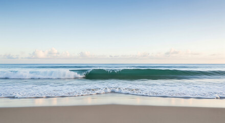 Obraz premium A tranquil wave rolls onto a pristine sandy beach under a bright blue sky