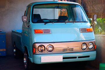 A vintage blue pickuo truck in a garage