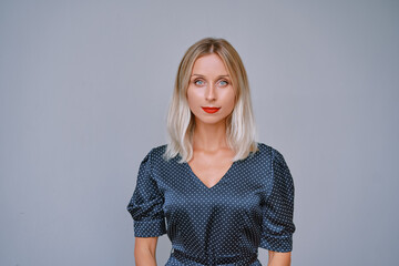 Stylish Woman in Polka Dot Dress Looking Confidently at the Camera